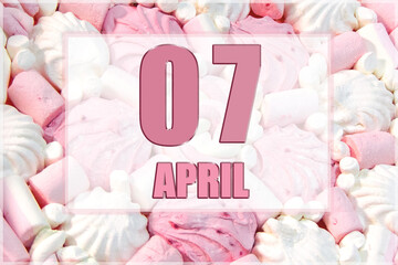 calendar date on the background of white and pink marshmallows.  April 7 is the seventh day of the month