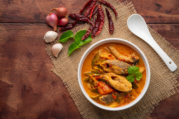 Tom yum pla,Creamy spicy soup with snake head fish tomato and mushroom,Thai hot and sour soup.Top view