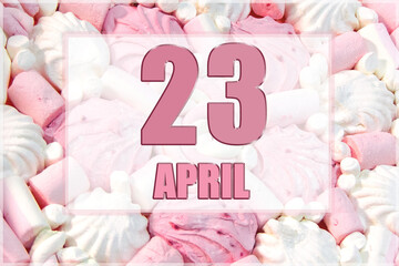 calendar date on the background of white and pink marshmallows. April 23 is the twenty-third  day of the month
