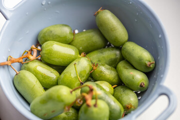mini baby kiwi in bowl, organic fruit from home garden 