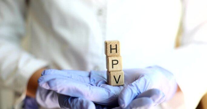 Abbreviation of human papillomavirus HPV in hands of doctor