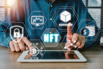 NFT token digital crypto art blockchain technology concept, Person hand using digital tablet with NFT icon on virtual screen.