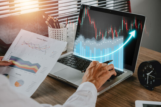 Business finance technology investment concept, Businessman working on computer with holographic graphs and stock market statistics gain profits, Stock Market Investments Funds and Digital Assets.