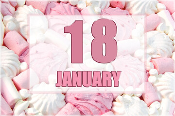 calendar date on the background of white and pink marshmallows. January 18 is the eighteenth day of the month