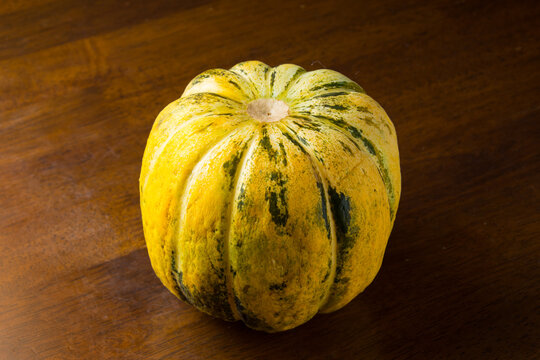 Blewah, Cantaloupe or Cucumis melo, a type of melon found in Indonesia, with a wooden background, cantaloupe is often used to make drinks during the fasting month of Ramadan