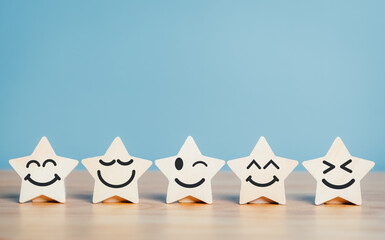 Wooden stars emoticon shape five stars rating service concept. satisfaction evaluation survey and...