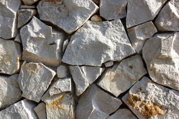 Stone wall background, rough rock wall close-up