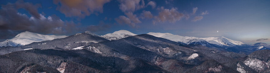 Fototapeta premium Picturesque winter night mountain view from Skupova mountain slope, Ukraine, view to Chornohora ridge and Pip Ivan mountain top with observatory building, Carpathian.