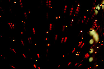 Fototapeta na wymiar Red lights in dark. Heralds on glass. Interior details. Red dots texture.