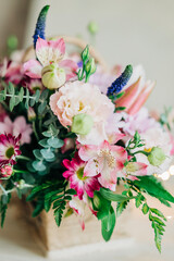 Beautiful pink flowers composition in the box close-up view. Festive decoration and background