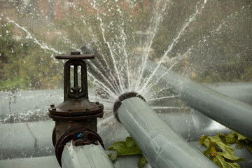 Pipeline accident. Boiling water pours from pipe. Boiler room emergency.