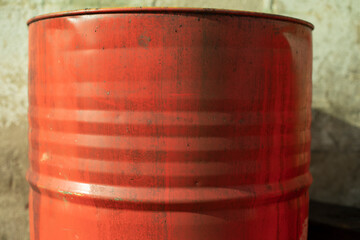 Obraz premium Red barrel for fuel. Oil barrel from stock. Steel tank.