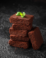 Chocolate brownies garnished with mint on cooling rack. Sweet food