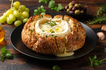 Photo sur Plexiglas Pain Baked Camembert cheese in sourdough bread with rosemary, garlic, thyme