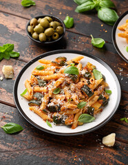 Zucchini penne pasta with parmesan cheese, basil and tomato. Healthy food