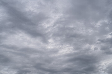 Fototapeta premium Gloomy sky with gray cumulus rain clouds during the day.