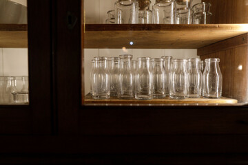 Shallow depth of field (selective focus) details with various glass vials used for old chemical and medical experiments inside a museum.