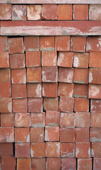 Obraz premium orange brown old brick stack off wall panel exterior design abstract background.for construction material backdrop,vintage or retro wallpaper design.