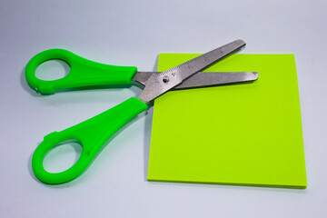 Metal scissors with green plastic parts