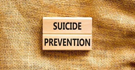 Suicide prevention symbol. Concept words Suicide prevention on wooden blocks. Beautiful canvas table canvas background. Psychological and suicide prevention concept. Copy space.