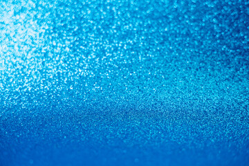 Blue sparkle glitter abstract background.