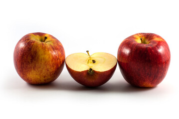 Slice and whole red apples arranged horizontally isolated on white background.