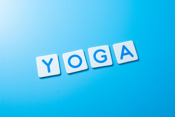 Word YOGA on blue background,YOGA Concept