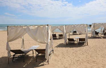 Fototapeta na wymiar gazebo to shelter from the sun on the sunny beach in summer in a Resort