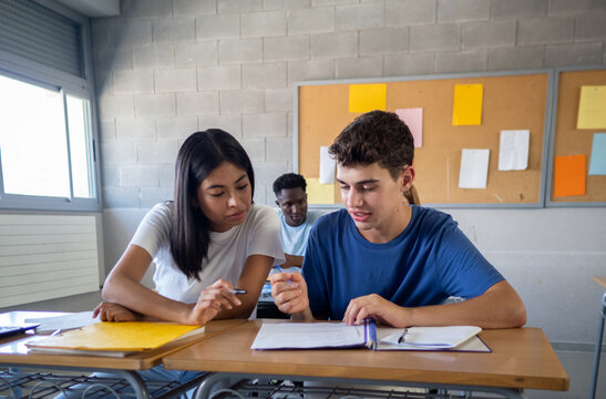 Two teenage students working as a team in a class at high school. education concept