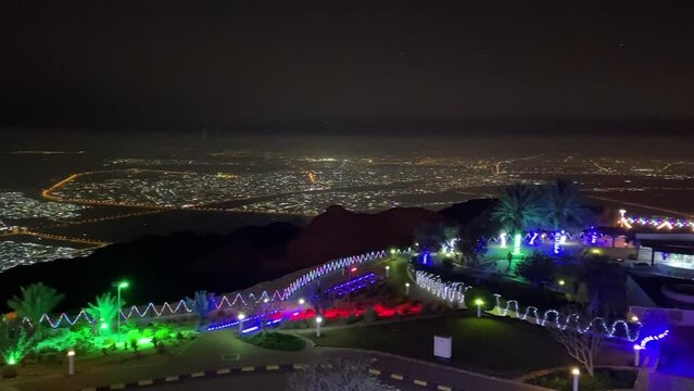 A Panorama of Al Ain, United Arab Emirates View at Night from Jebal Hafeet (Jebel Hafit) showing the city lights from the top of the mountain.