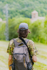 Unrecognizable man on his back in nature in camouflage clothing.