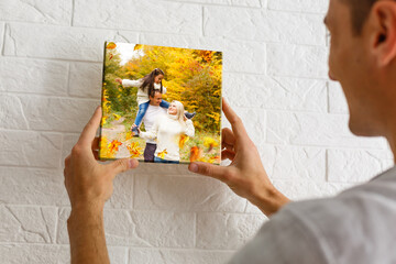 Canvas print with gallery wrap. man hangs autumn photography, photocanvas