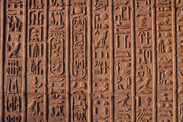 Ancient egyptian hieroglyphics carved on walls of Kom Ombo temple, Aswan, Egypt 
