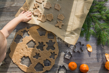New Year and Christmas decorations on a wooden surface with flour, tangerines and a Christmas tree....