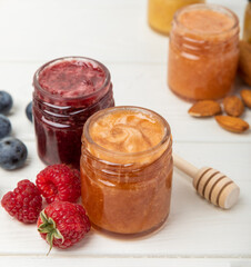 Honey in a glass jar. Raspberry and blueberry honey jam. Remedy for colds and respiratory diseases. Organic product of a vegetarian diet. copy space. copy space