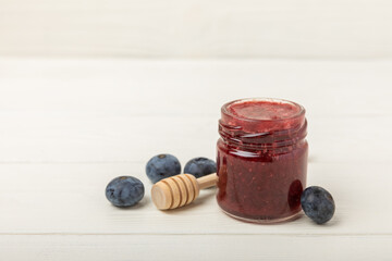 Honey in a glass jar. Raspberry and blueberry honey jam. Remedy for colds and respiratory diseases. Organic product of a vegetarian diet. copy space. copy space
