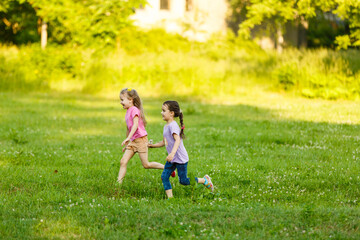 Fototapeta premium two little girls walking in the field.