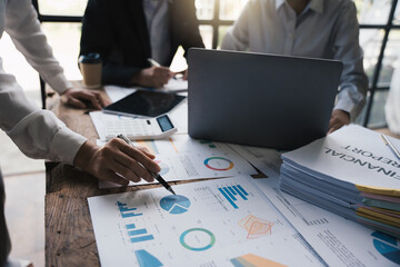 Team of business investment consultant analyzing company annual financial report working with...