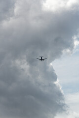 Fototapeta na wymiar Airplane landing with storm clouds in background