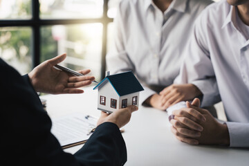 Real estate broker agents are presenting home loan to customer to buy a house with insurance, Agreement to sign the purchase contract concept.