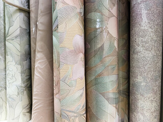 New rolls of wallpaper are displayed on the store shelf.