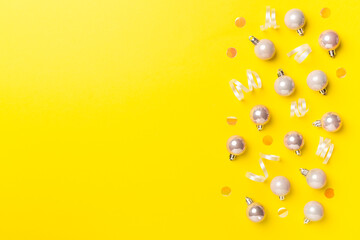 Christmas balls on color background, top view