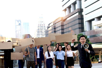 Fototapeta premium Crowds of discontented people hold blank banners placards protesting at city, leader shouts through megaphone with men and women group rebellions doing protest, protesters at political rally parade