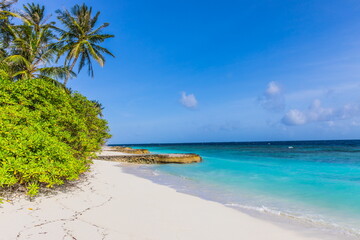 Tropical sand beach and blue sky with white clouds in the Maldives