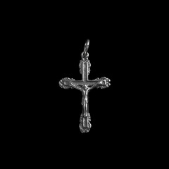 Silver crucifix necklace cross isolated on black background