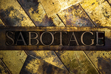 Sabotage text on grunge textured copper and gold background