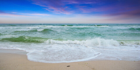 velvet season seascape. waves rushing on the beach. cloudy sky before the evening storm