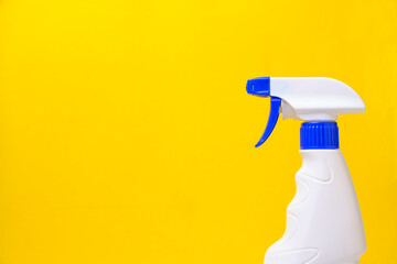 Sprayer for washing windows and plumbing yellow background.