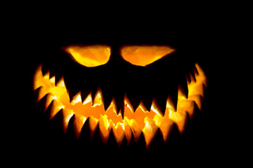 Halloween pumpkin glowing face in the dark.