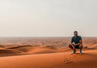 Fototapeta na wymiar Sunset in the desert with a man